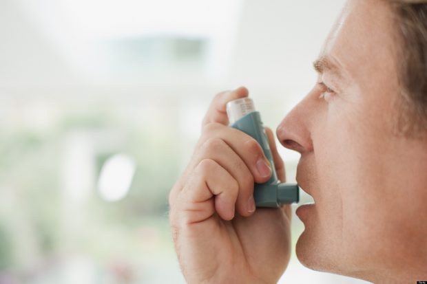 Adult with asthma using Inhaler